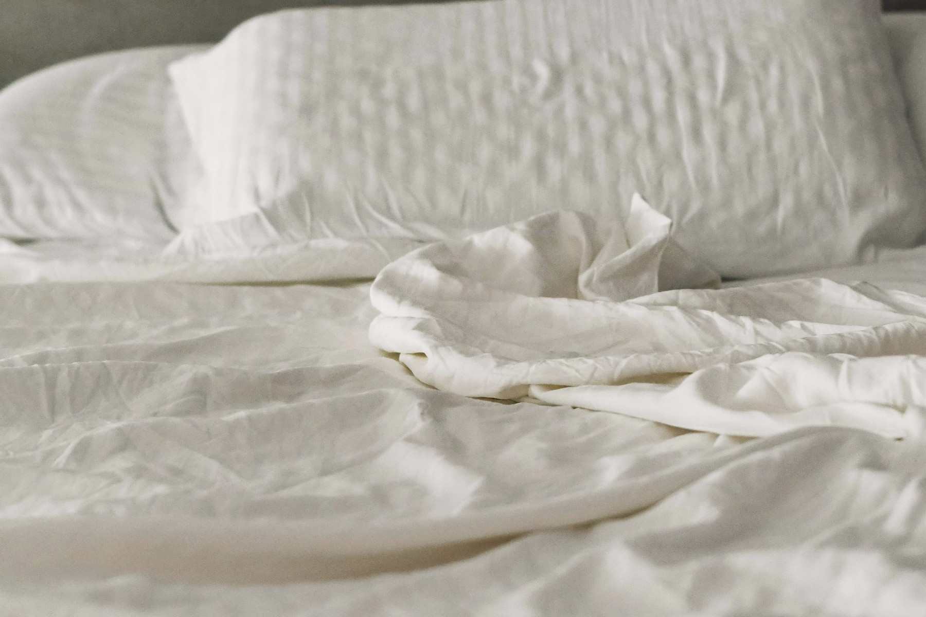 Unmade washed linen in morning light